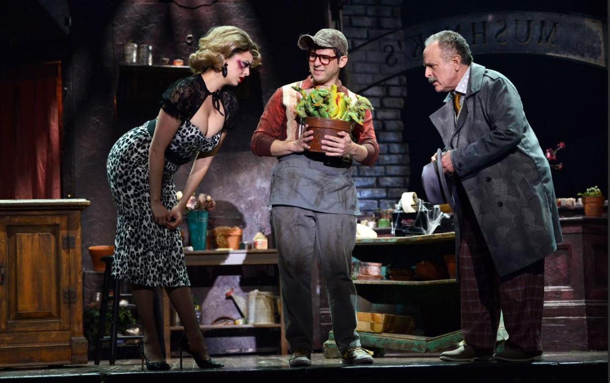 Actor Adam Heller, right. appears as floral shop owner Mr. Mushnick alongside Talia Suskauer, left, and Etai Benson in The Ogunquit Playhouse's current production of the macabre musical, "Little Shop of Horrors."