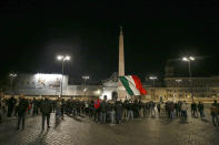 People gather in Piazza del Popolo square during a protest called by Forza Nuova far right group against the government restriction measures to curb the spread of COVID-19, in Rome Saturday, Oct. 24, 2020. A midnight-to-5 a.m. curfew in Italy's Lazio region, which includes Rome, begins on Friday and lasts for 30 days, under orders from regional governor Nicola Zingaretti. (Cecilia Fabiano/LaPresse via AP)