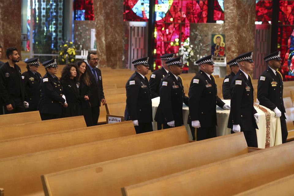 The family of Chicago police Officer Luis Huesca, including his mother Edith Huesca, and his sister, Lily O'Brien, follow his casket inside St. Rita of Cascia Shrine Chapel for his funeral on Monday, April 29, 2024. Hundreds of mourners lined the streets to say farewell to the police officer who was shot to death while off-duty and heading home from work. (Antonio Perez/Chicago Tribune via AP, Pool)