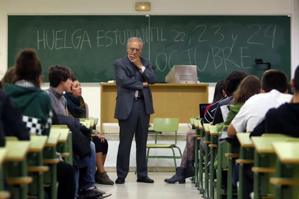 <p>A professor stands in front of a blackboard where protesting students have written, “Student Strike, 22, 23 and 24 of October,” as students ask him to join the protest against increases in university tuition and budget cuts to education at Complutense University in Madrid, Oct. 22, 2013. (AP Photo/Andres Kudacki) </p>