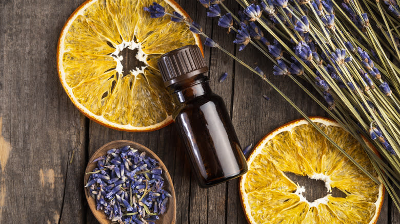 Lavender, an oil bottle and dried orange slices