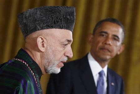 Afghan President Hamid Karzai (L) addresses a joint news conference with U.S. President Barack Obama in the East Room of the White House in Washington, January 11, 2013. REUTERS/Jason Reed