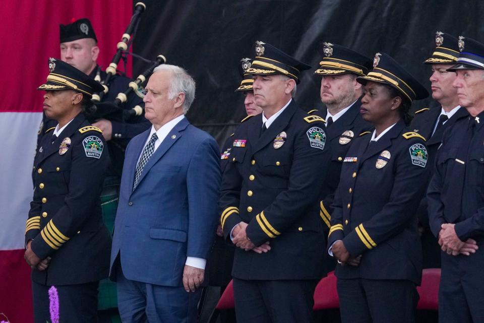 At far left, Interim Chief of Police Robin Henderson and Austin City Mayor Kirk Watson with other officials look on as they pay respect to fallen Austin police officer Jorge Pastore during the funeral service at the Germania Insurance Amphitheater on Friday, Nov. 17, 2023. Pastore, 38, was killed by a gunman on Saturday, Nov. 11, 2023.