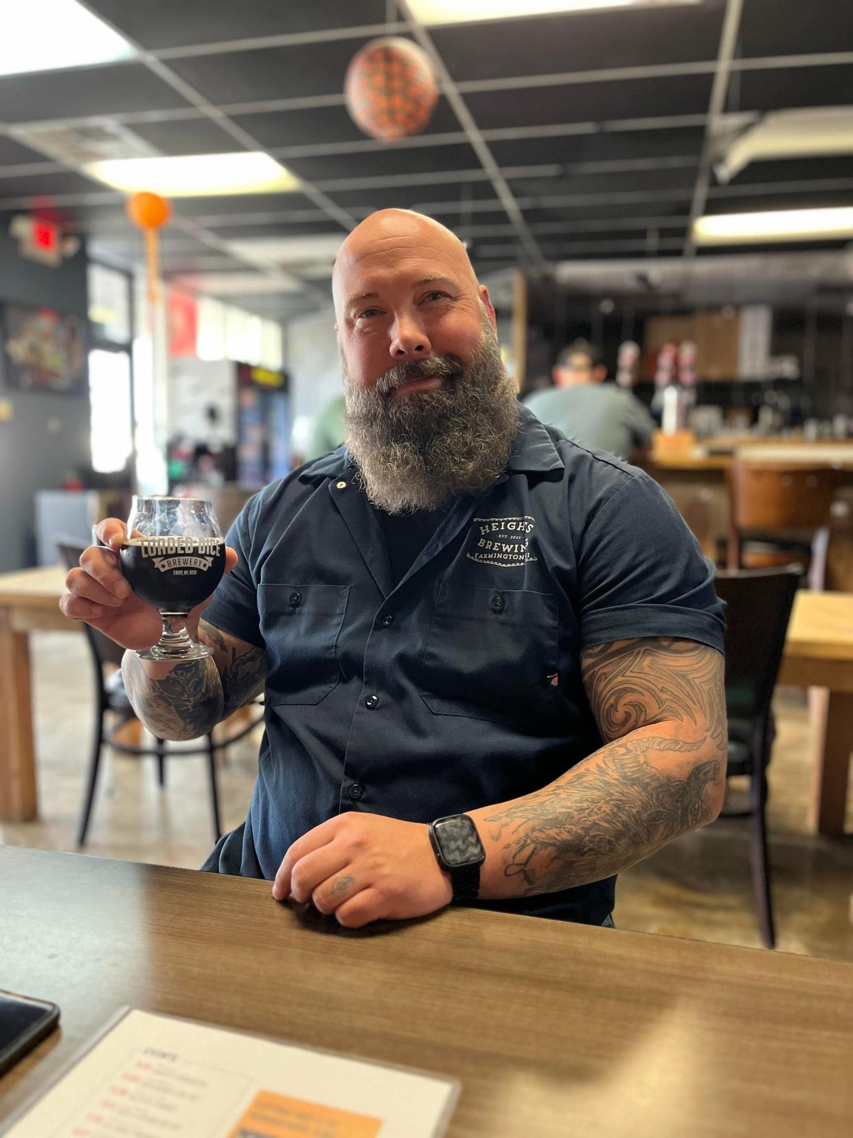 Ryan Kavanagh, co-founder of Heights Brewing in Farmington, holding a glass of Vor's Gone Phishing, a beer collaboration with Loaded Dice Brewery.