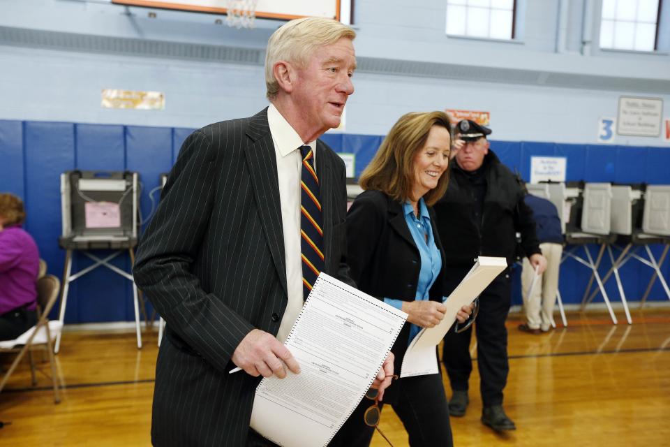Former Massachusetts Gov. Bill Weld and his wife, Leslie Marshall, hold ballots before casting their votes at the John F. Kennedy Elementary School in Canton, Massachusetts. (Photo: ASSOCIATED PRESS)