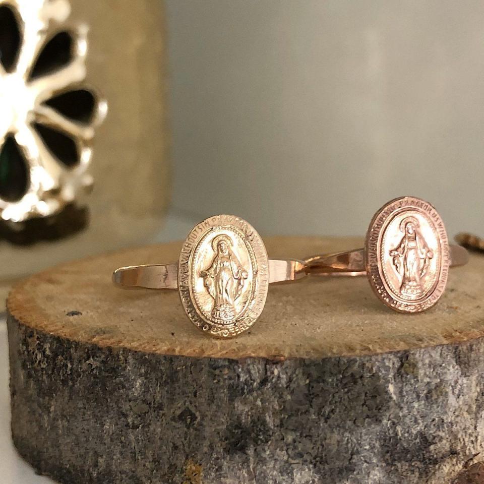 <p>isabellegracejewelry.com</p><p><strong>$62.00</strong></p><p><a href="https://www.isabellegracejewelry.com/collections/faith-collection/products/miraculous-medal-ring?variant=17881220776001" rel="nofollow noopener" target="_blank" data-ylk="slk:Shop Now;elm:context_link;itc:0;sec:content-canvas" class="link ">Shop Now</a></p><p>Though small in size, this gorgeous ring is a powerful reminder for your faith-filled graduate to trust in the power and impact of prayer.</p>