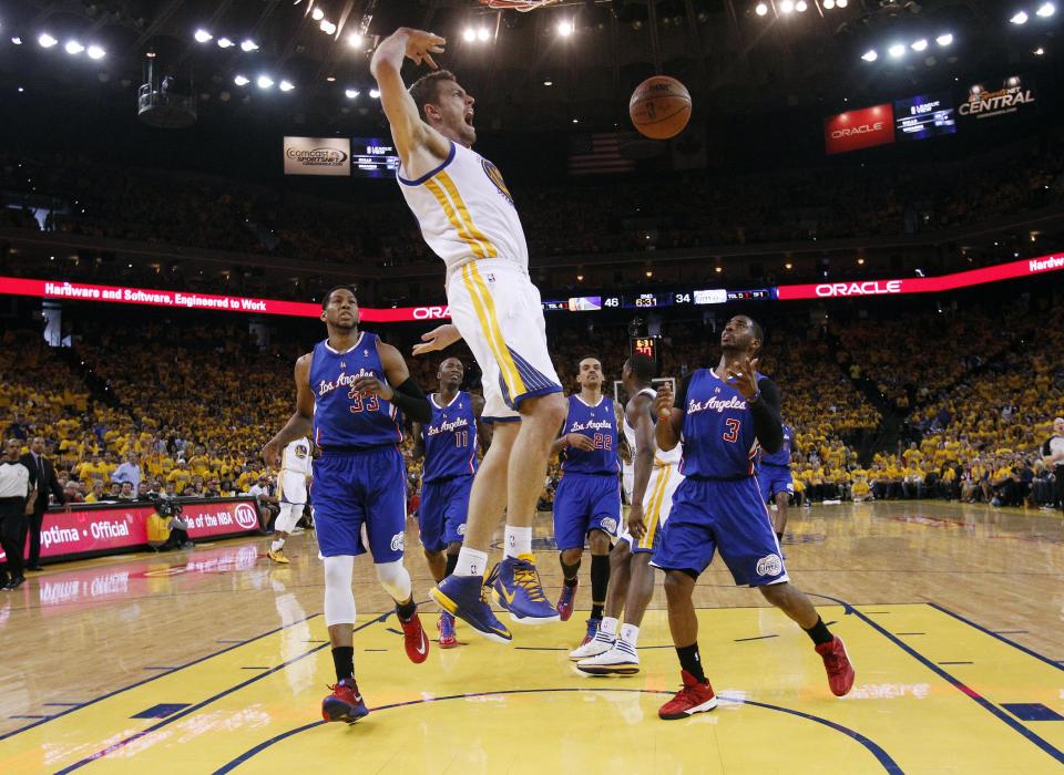 Golden State Warriors' David Lee, center, dunks next to Los Angeles Clippers' Danny Granger (33), and Chris Paul (3) during the first half in Game 4 of an opening-round NBA basketball playoff series on Sunday, April 27, 2014, in Oakland, Calif. (AP Photo/Marcio Jose Sanchez)