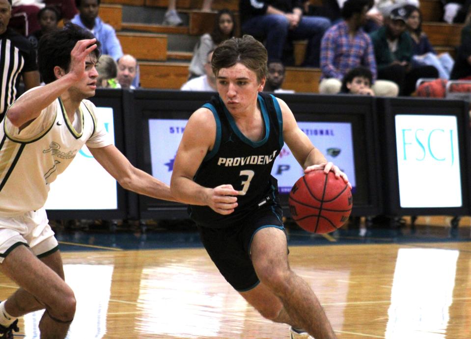 Providence guard Brady Patterson (3) drives on the dribble as Nease guard Andy Gonzalez defends during the High School 9:12 Fortegra Invitational for boys basketball at FSCJ South Campus on Saturday night.