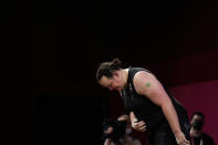 Laurel Hubbard of New Zealand says "Thank you" and bows after lifting, in the women's +87kg weightlifting event at the 2020 Summer Olympics, Monday, Aug. 2, 2021, in Tokyo, Japan. (AP Photo/Seth Wenig)