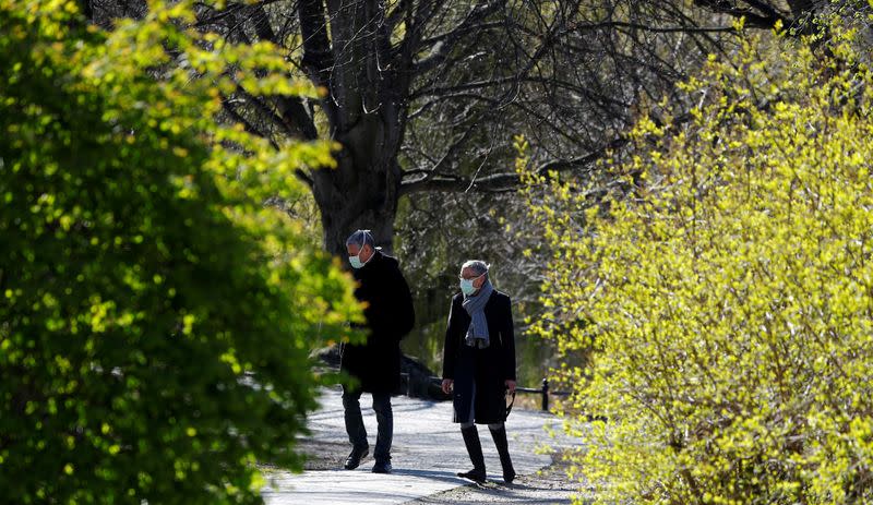 FILE PHOTO: People walk at Lietzensee lake as the spread of the coronavirus disease (COVID-19) continues in Berlin