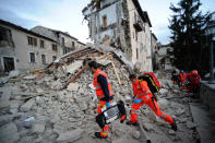 <p>Rescuers search a crumbled building in Arcuata del Tronto, central Italy, where a 6.1 earthquake struck just after 3:30 a.m., Wednesday, Aug. 24, 2016. The quake was felt across a broad section of central Italy, including the capital Rome where people in homes in the historic center felt a long swaying followed by aftershocks. (AP Photo/Sandro Perozzi) </p>