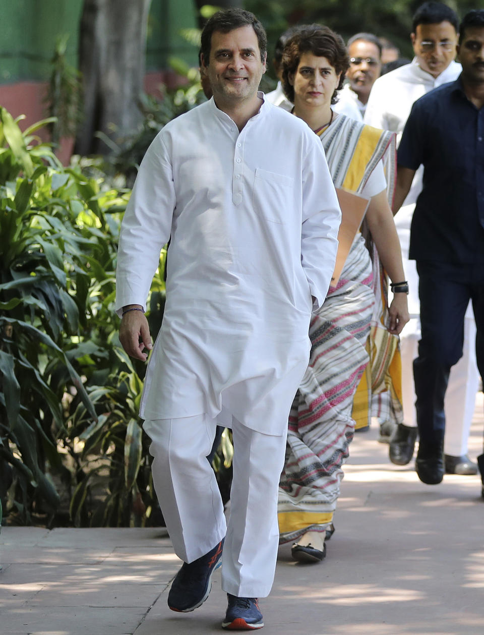 Congress party President Rahul Gandhi arrives for a Congress Working Committee meeting, followed by his sister Priyanka Gandhi Vadra, in New Delhi, India, Saturday, May 25, 2019. The BJP's top rival, led by Gandhi, won 52 seats. (AP Photo/Altaf Qadri)