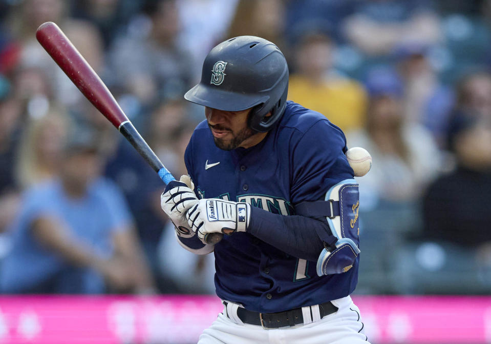 Seattle Mariners' Jose Caballero is hit by a pitch from Oakland Athletics starter JP Sears during the fifth inning of a baseball game Thursday, May 25, 2023, in Seattle. (AP Photo/John Froschauer)