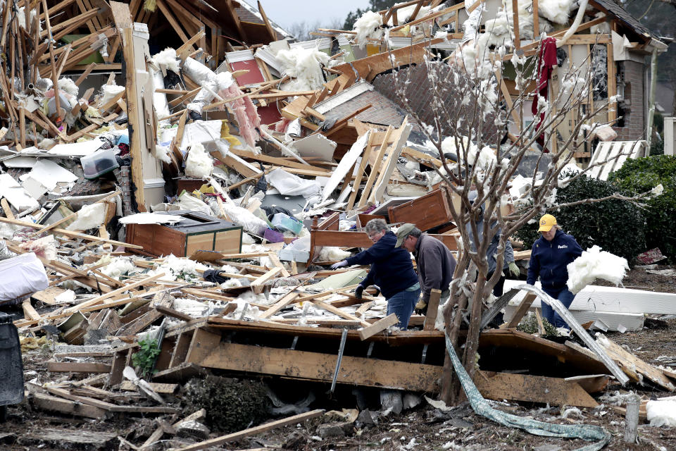 People sift through the rubble of homes at the Ocean Ridge Plantation in Brunswick County, N.C., Wednesday, Feb. 17, 2021, after a tornado hit the area Monday night. (AP Photo/Chris Seward)