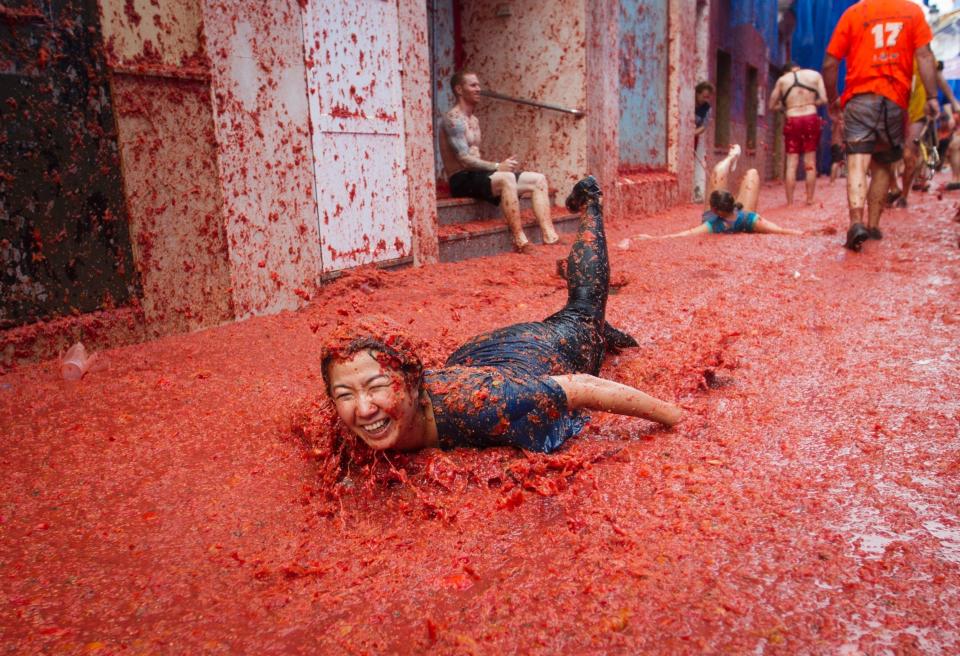 Many, like&nbsp;the two women pictured here, end up falling flat out on the ground during the food fight.