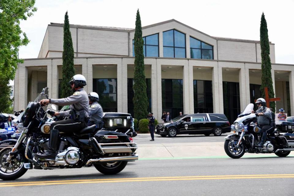 A hearse carries the body of Officer Joshua Eyer leaves First Baptist Church to burial site at Sharon Memorial Park in Charlotte, NC on Friday, May 3, 2024. Officer Joshua Eyer who died from wounds sustained during a standoff with a gunman on Monday, April 29th. Three other law enforcement officers were also killed in the shootout.