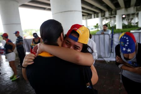 A Venezuelan woman cries as she protests outside the site where the Organization of American States (OAS) 47th General Assembly is taking place in Cancun, Mexico June 21, 2017. REUTERS/Carlos Jasso