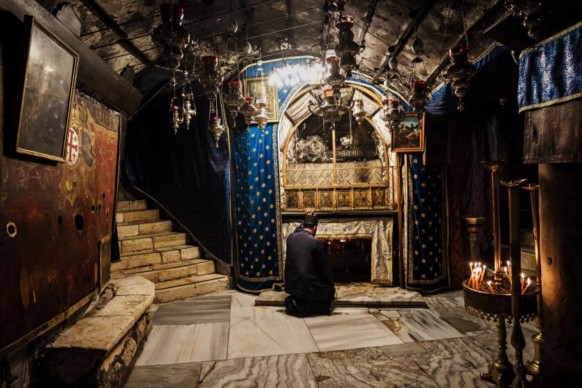 BETHLEHEM, OCCUPIED WEST BANK -- DECEMBER 16, 2023: Fr. Issa Thaljieh poses for a portrait inside the Grotto of the Nativity, an underground crypt, where Jesus is said to have been born, underground inside the Church of the Nativity in Bethlehem, Occupied West Bank , Saturday, Dec. 16, 2023. Palestinian Christians are marking a somber Christmas this year, canceling festivities in solidarity with suffering in the Gaza Strip as the war between Israel and Hamas grinds on. In Bethlehem, the West Bank town revered by Christians as the place of Jesus' birth, prayers, church services and the annual procession of Christian patriarchs will go on as usual, but more joyous holiday trappings have gone by the wayside: no twinkling Christmas lights, no elaborately decorated tree in Manger Square, no parade with marching bands. "How could we celebrate?" asked the town's mayor. (MARCUS YAM / LOS ANGELES TIMES)