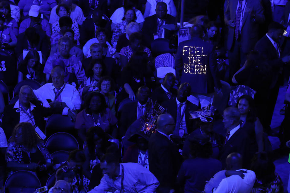 <p>The lighted back of a Bernie Sanders supporter’s jacket stands out among the delegates during the first day of the Democratic National Convention in Philadelphia , Monday, July 25, 2016. (AP Photo/Mary Altaffer)</p>