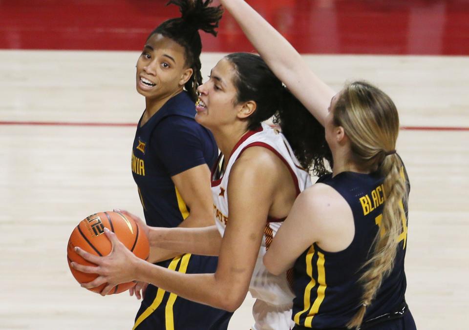 Iowa State's Stephanie Soares takes a shot between West Virginia's JJ Quinerly and forward Kylee Blacksten during Thursday's games in Ames.