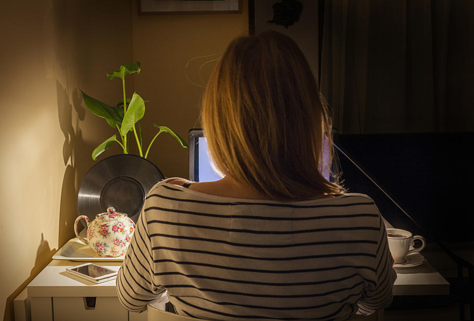 A woman sitting at her computer.