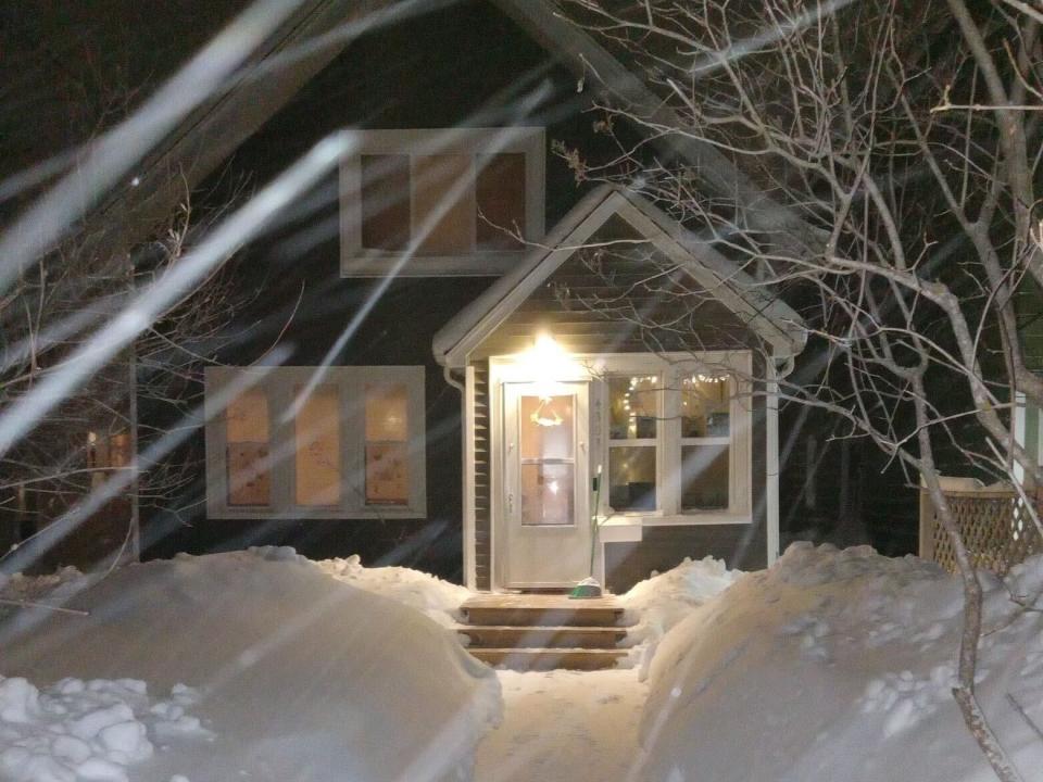 The family's home on a winter night.