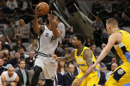 FILE PHOTO: Jan 13, 2018; San Antonio, TX, USA; San Antonio Spurs small forward Kawhi Leonard (2) passes the ball against Denver Nuggets small forward Wilson Chandler (21) during the first half at AT&T Center. Mandatory Credit: Soobum Im-USA TODAY Sports