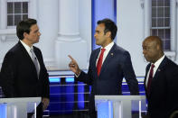 Republican presidential candidate businessman Vivek Ramaswamy talks with Florida Gov. Ron DeSantis as Sen. Tim Scott, R-S.C., listens during a Republican presidential primary debate hosted by NBC News, Wednesday, Nov. 8, 2023, at the Adrienne Arsht Center for the Performing Arts of Miami-Dade County in Miami. (AP Photo/Rebecca Blackwell)