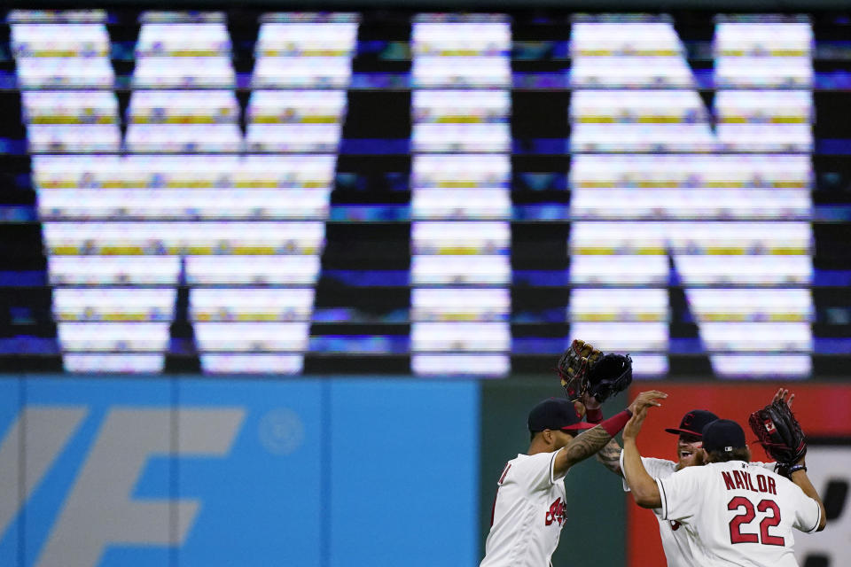 Cleveland Indians' Eddie Rosario, Ben Gamel and Josh Naylor, from left, celebrate after the Indians defeated the Detroit Tigers 4-1 in a baseball game Friday, April 9, 2021, in Cleveland. (AP Photo/Tony Dejak)