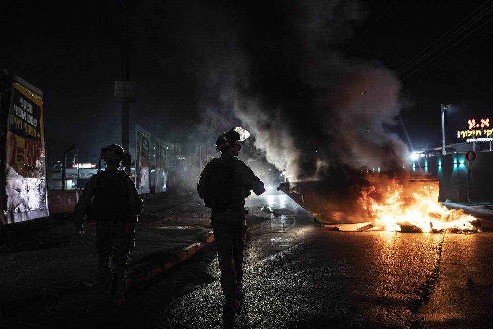 Image: Israeli police patrol during clashes between Arabs, police and Jews in Lod (Heidi Levine / AP)