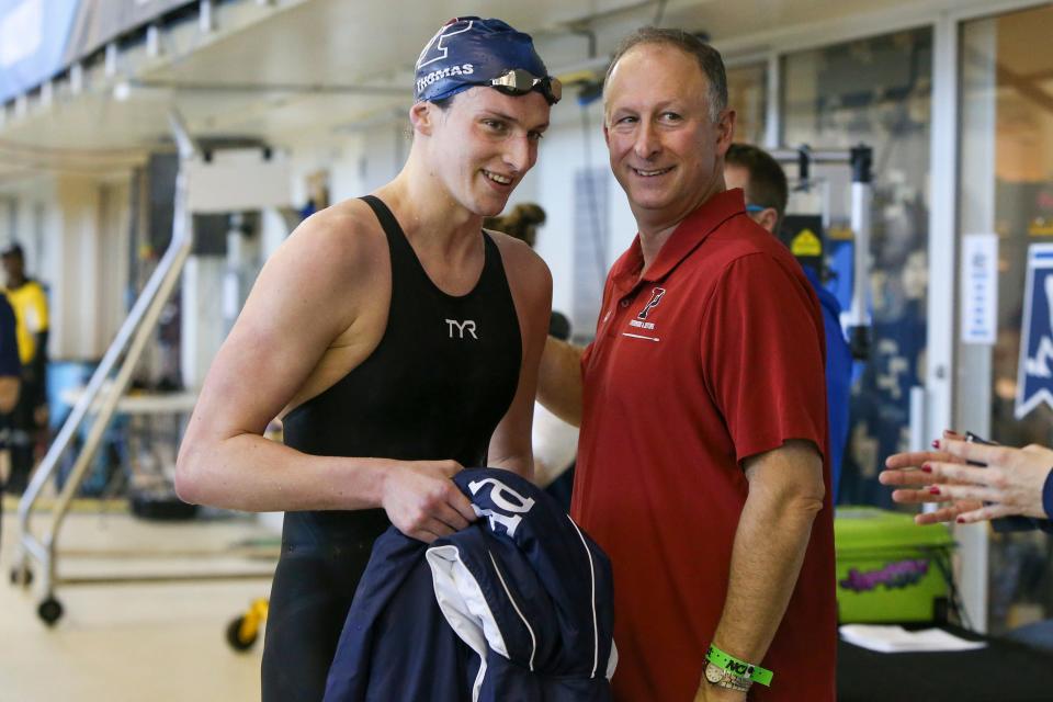 Penn swimmer Lia Thomas talks to head coach Mike Schnur after the 500 free prelim.