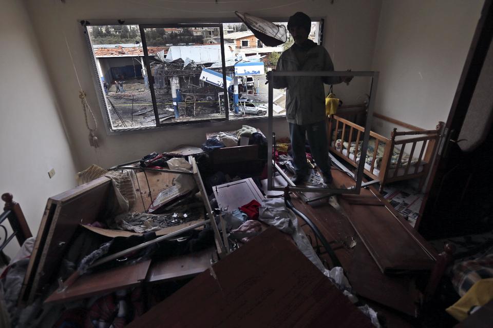 A Lebanese man checks the damage inside his children's bedroom that was caused by a deadly car bomb that exploded Saturday evening near a gas station, in the predominately Shiite town of Hermel, about 10 miles (16 kilometers) from the Syrian border in northeast Lebanon, Sunday, Feb. 2, 2014. A shadowy Lebanese Sunni extremist group late Saturday claimed responsibility for a suicide car bombing in Hermel, a stronghold of Lebanon's Shiite militant Hezbollah group, that killed several people in the latest attack linked to the war in neighboring Syria. (AP Photo/Hussein Malla)