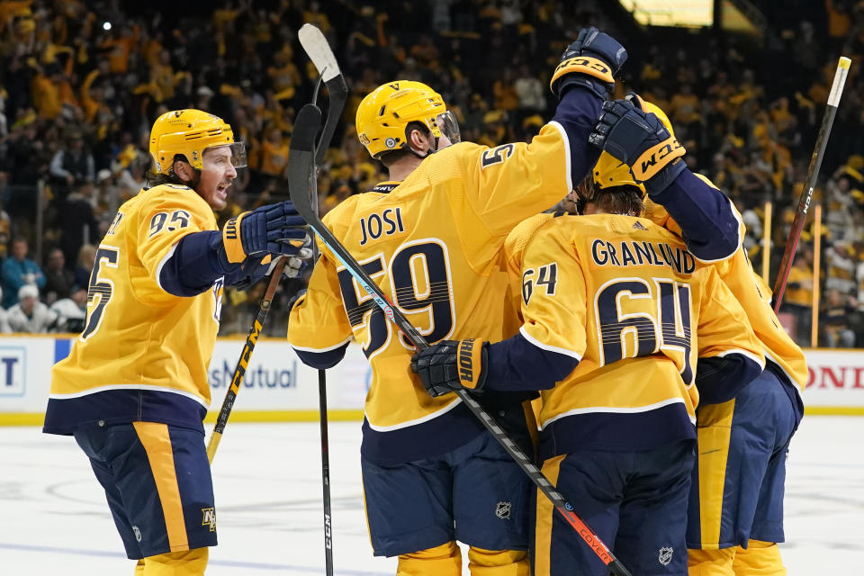 Nashville Predators center Matt Duchene (95) joins the celebration after Predators left wing Filip Forsberg scored a goal against the San Jose Sharks in the second period of an NHL hockey game Tuesday, Oct. 26, 2021, in Nashville, Tenn. (AP Photo/Mark Humphrey)