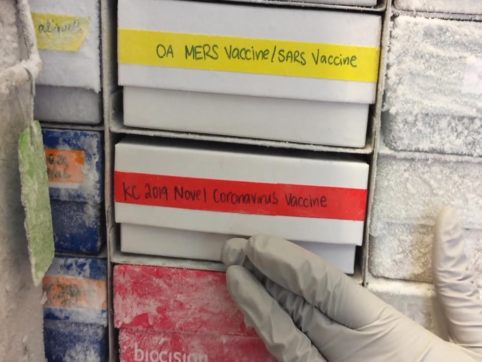 In this undated frame from video provided by the National Institute of Allergy and Infectious Diseases (NIAID), a scientist returns a novel coronavirus vaccine sample to a freezer in Bethesda, Md. The flu-like virus that exploded from China has researchers worldwide once again scrambling to find a vaccine against a surprise health threat, with no guarantee one will arrive in time. (NIAID via AP)