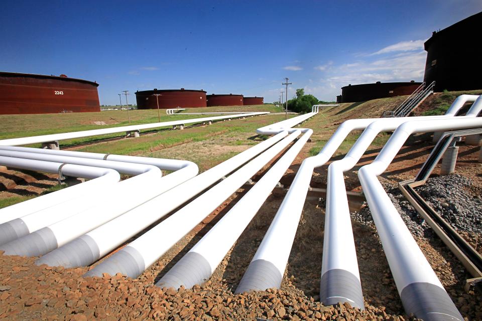 A maze of pipes connect storage tanks with interstate pipelines at Enbridge Inc.’s storage yard in Cushing. U.S. Energy Secretary Ernest Moniz said last week the Obama Administration is studying whether to change the 40-year-old ban on most domestic oil exports.