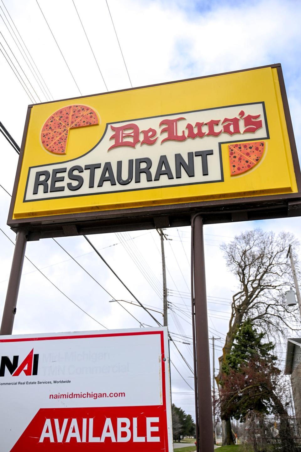 The sign for the former DeLuca's Restaurant on West Willow Street on Wednesday, March 20, 2024, in Lansing.