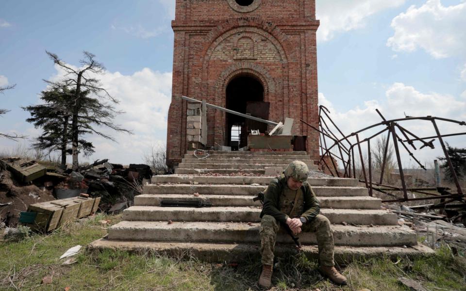 A Ukrainian serviceman stands near the front line with Russia backed separatists in the small town of Pisky, near Donetsk