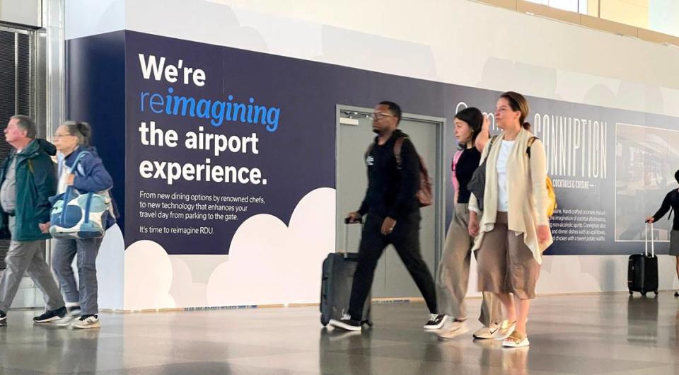 Passengers walk by the future home of Conniption Cocktails & Cuisine at Raleigh-Durham International Airport on April 9, 2024.