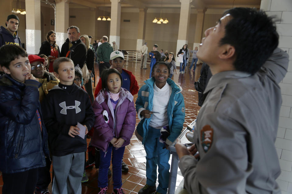 Fourth-graders from Swain School in Allentown, Pa., listen to a park ranger on Ellis Island in New York, Monday, Oct. 28, 2013. The island that ushered millions of immigrants into the United States received visitors Monday for the first time since Superstorm Sandy. Sandy swamped boilers and electrical systems and left the 27.5-acre island without power for months. (AP Photo/Seth Wenig)