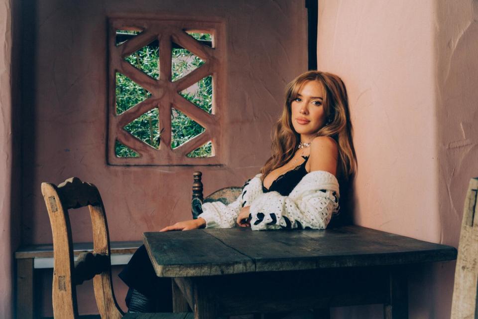 A woman sits at a table.