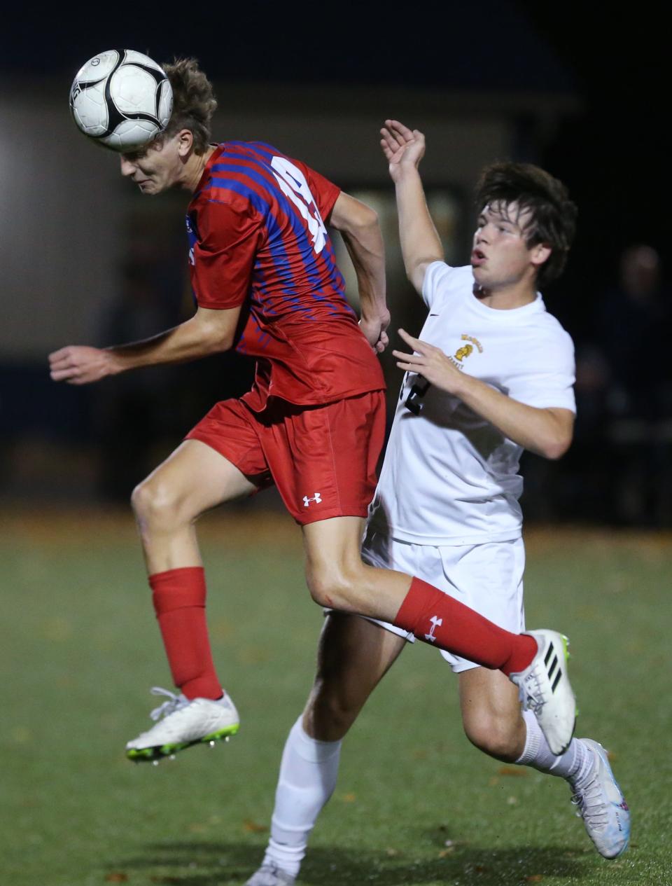 Fairport's Alexander Grejda gets to ball ahead of McQuaid's Kevin Miller during their Section V Class AAA championship final Friday, Oct. 27, 2023 at Spencerport.