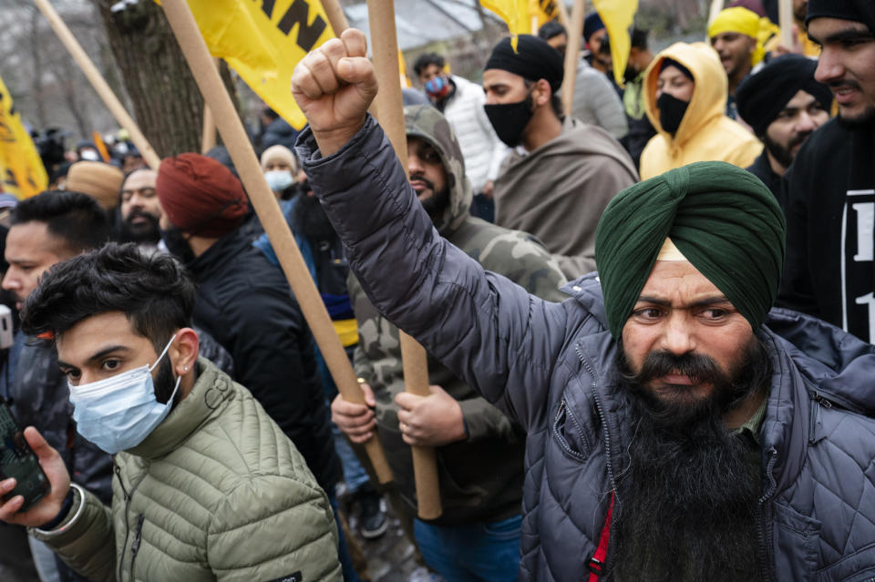 Protesters gather on Fifth Avenue outside the Consulate General of India, Tuesday, Jan. 26, 2021, in the Manhattan borough of New York. Tens of thousands of protesting farmers have marched, rode horses and drove long lines of tractors into India's capital, breaking through police barricades to storm the historic Red Fort. The farmers have been demanding the withdrawal of new laws that they say will favor large corporate farms and devastate the earnings of smaller scale farmers. Republic Day marks the anniversary of the adoption of India’s constitution on Jan. 26, 1950. (AP Photo/John Minchillo)