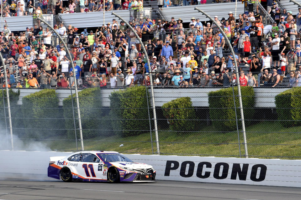 Denny Hamlin celebrates with a burnout after winning a NASCAR Cup Series auto race, Sunday, July 28, 2019, in Long Pond, Pa. (AP Photo/Derik Hamilton)