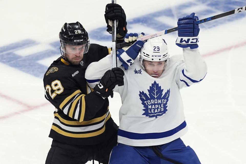 Boston Bruins' Parker Wotherspoon, left, battles Toronto Maple Leafs' Pontus Holmberg during the first period of Game 7 of an NHL hockey Stanley Cup first-round playoff series, Saturday, May 4, 2024, in Boston. (AP Photo/Michael Dwyer)