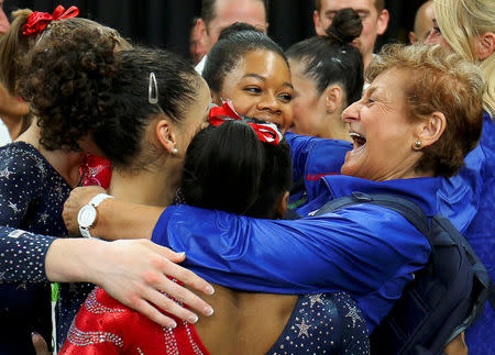 FILE PHOTO: Team Coordinator Marta Karolyi (R) hugs Gabby Douglas, Aly Raisman, Laurie Hernandez, Simone Biles and Madison Kocian of USA during the women's qualifications at the 2016 Rio Olympics in Rio de Janeiro, Brazil, August 7, 2016. REUTERS/Mike Blake