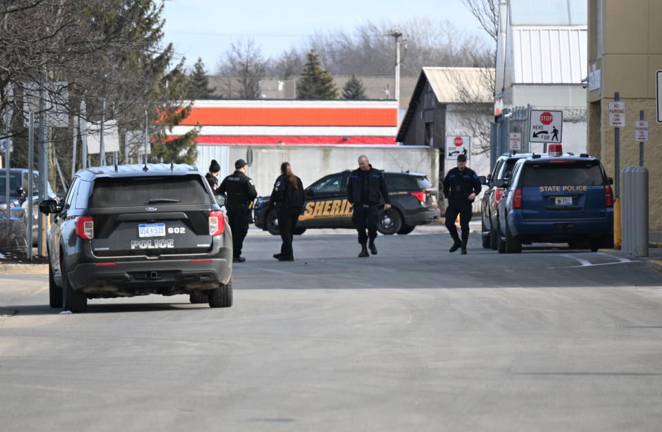 Coldwater Police, Branch County Sheriff deputies, and Michigan State Police wait while a bomb-sniffing dog and personnel search the Coldwater Walmart.