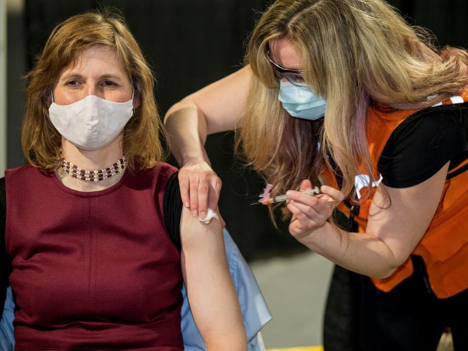 Yukon's acting chief medical officer of health, Dr. Catherine Elliott receives her COVID-19 vaccine in March 2021. On Monday, the territorial government declared a state of emergency, announcing new health regulations. (Mike Thomas/The Canadian Press - image credit)