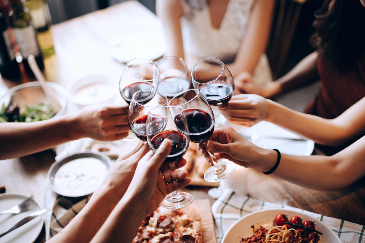 Toast with red wine at dinner with your friends. (PHOTO: Getty Images)