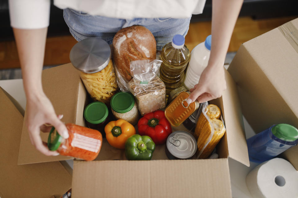 volunteer assembling a food box