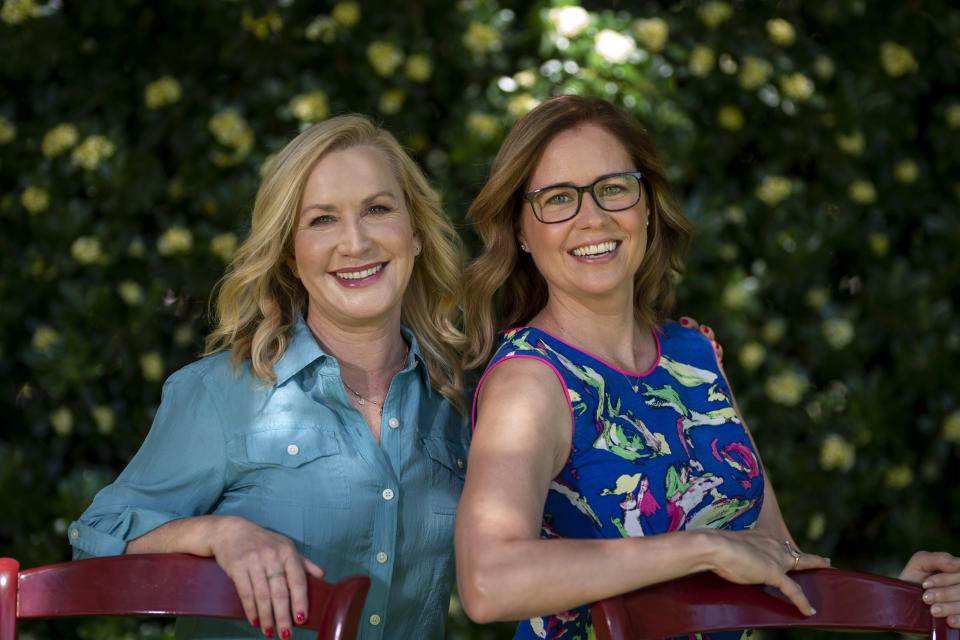 Angela Kinsey, left, and Jenna Fischer, friends and former co-stars of the comedy series "The Office" pose for photos in Glendale, Calif., Tuesday, March 22, 2022, to promote their book "The Office BFFs: Tales of The Office from Two Best Friends Who Were There." (AP Photo/Jae C. Hong)